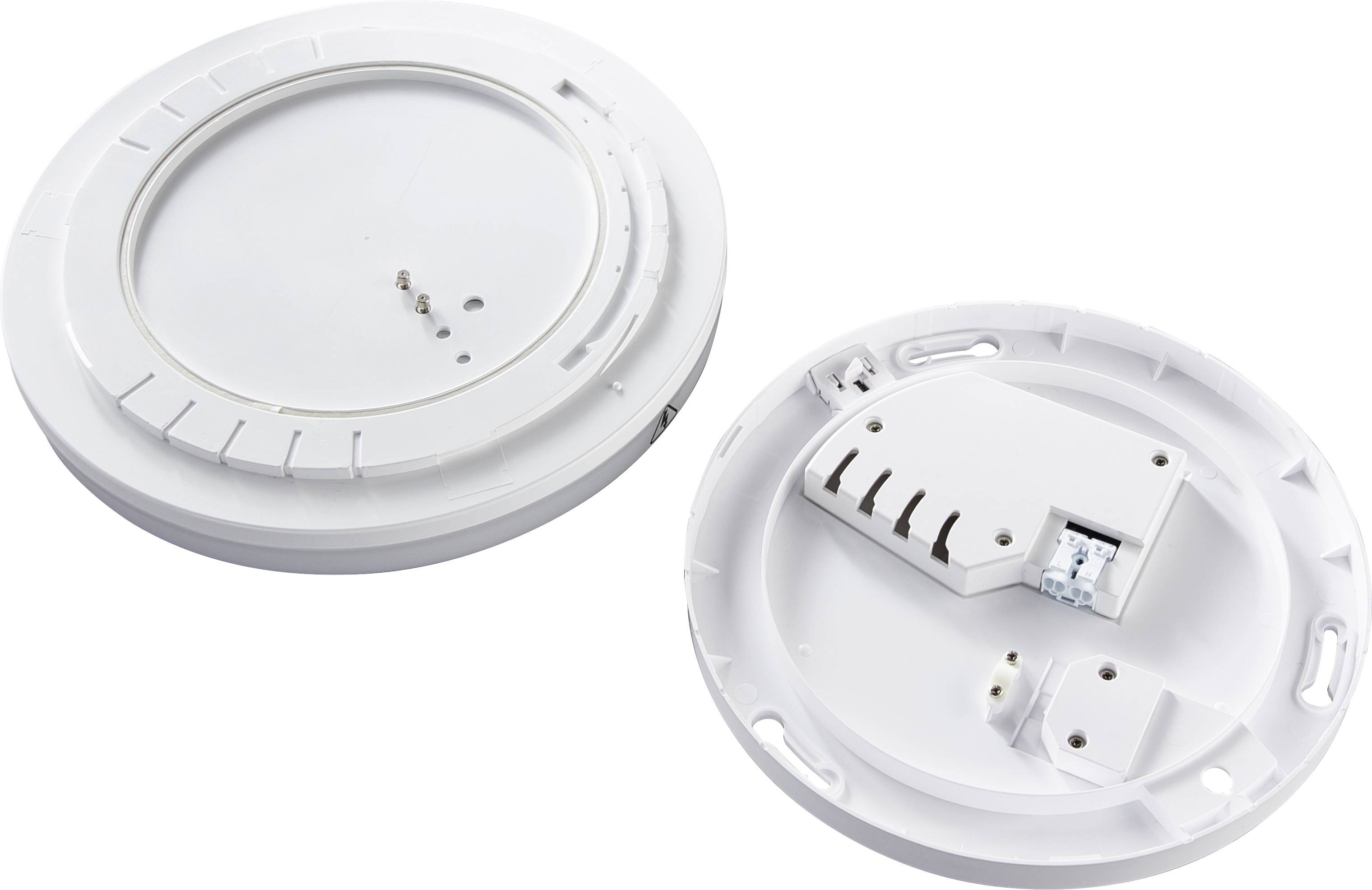 Two round, white plastic casings. One shows pins and connection options, the other is closed. They look technical.