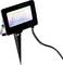 LED floodlight with ground spike, black housing, illuminated display with colour gradient, connected cable. Ideal for outdoor lighting.