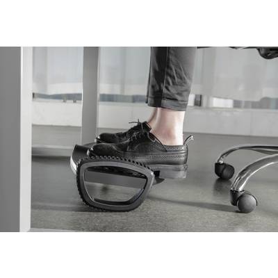 A person is sitting at a desk and using an ergonomic footrest to support their feet and increase comfort.