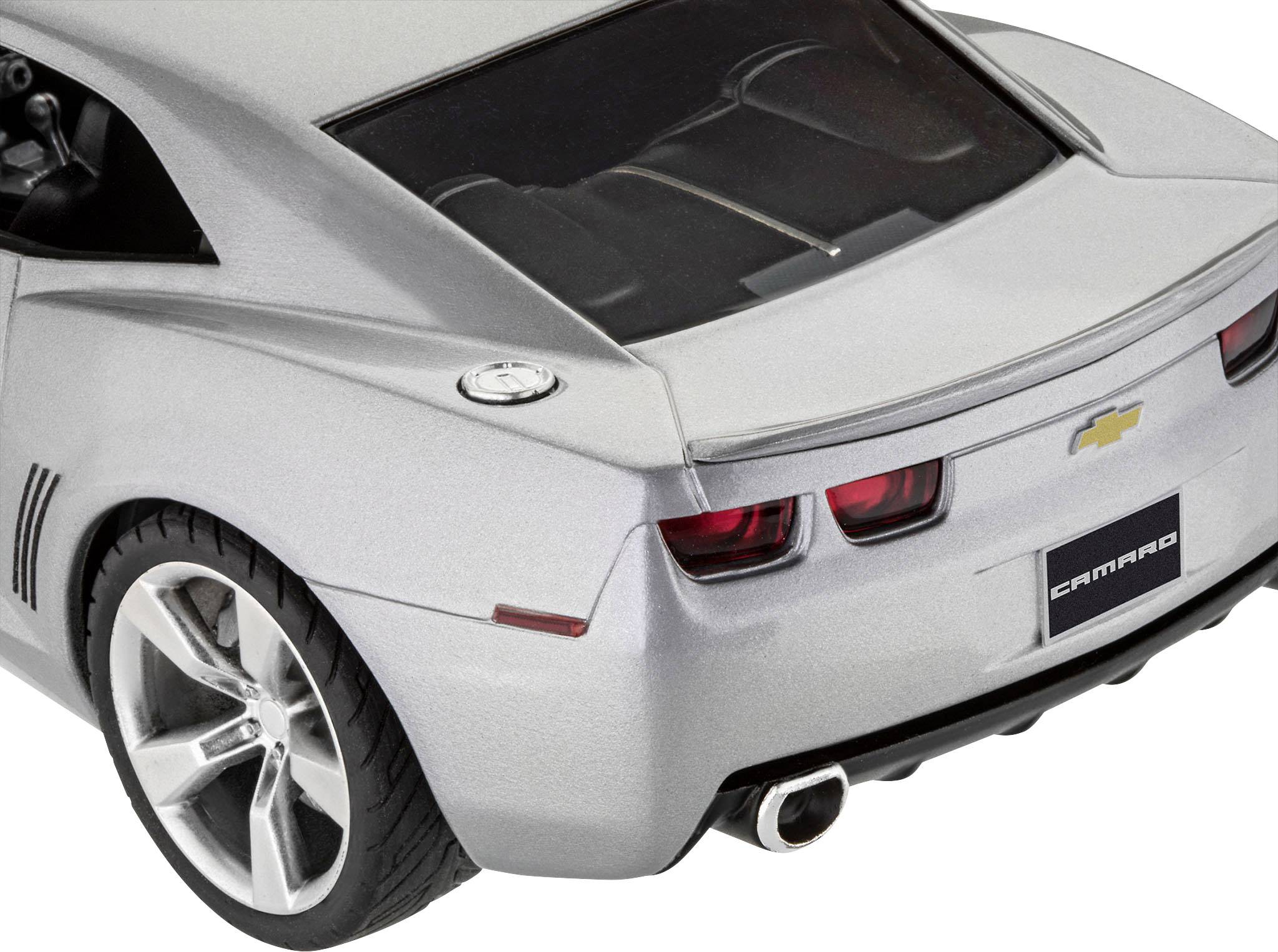 Silver sports car from behind, visible rear lights and exhaust. Brand logo and 'Camaro' lettering on the number plate.