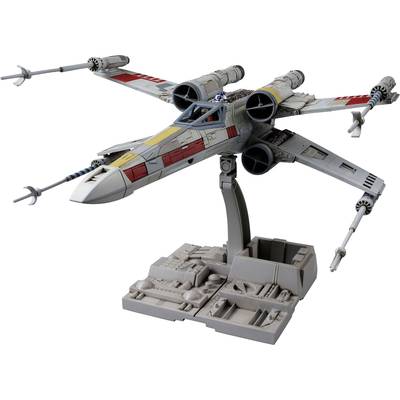 A model of a futuristic spacecraft with four wings in an X-formation on a stand. It has red and yellow markings.
