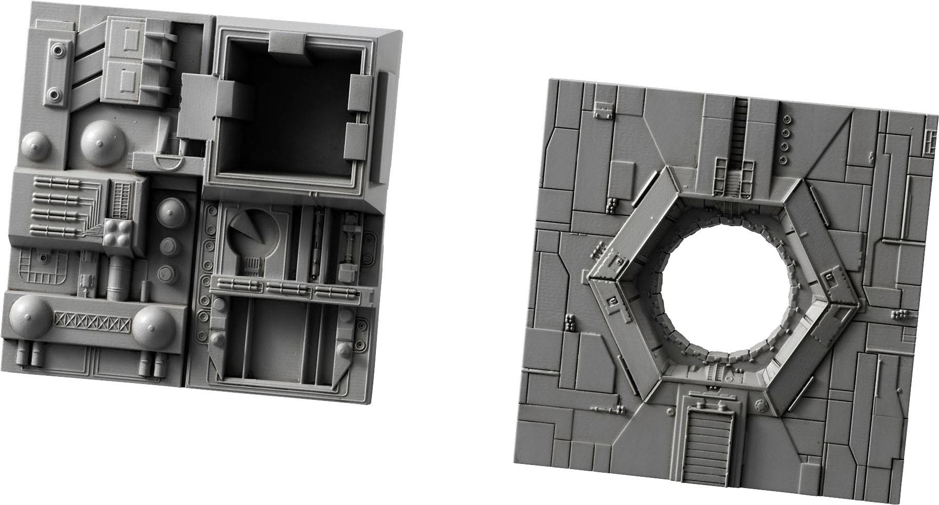 Two grey, detailed model components: on the left with square patterns, on the right with a large round hole in the centre.