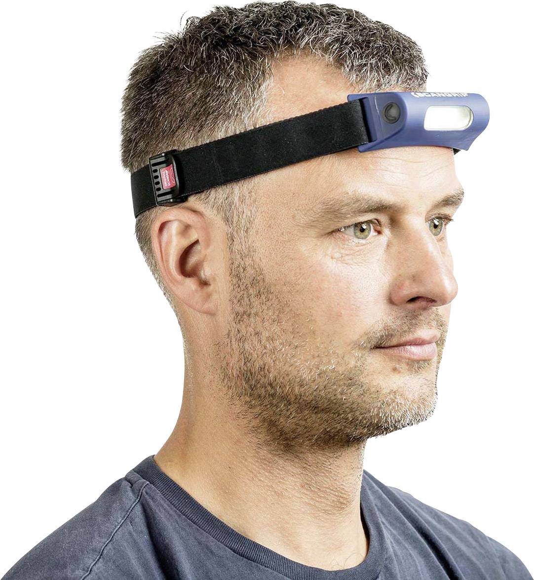 A man is wearing a head torch.