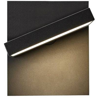 Black wall light with a rectangular shade, casting warm light downwards onto a brown surface. Minimalist design.