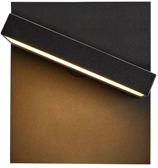 Black wall light with angled downward illumination, providing warm lighting on a wall surface.