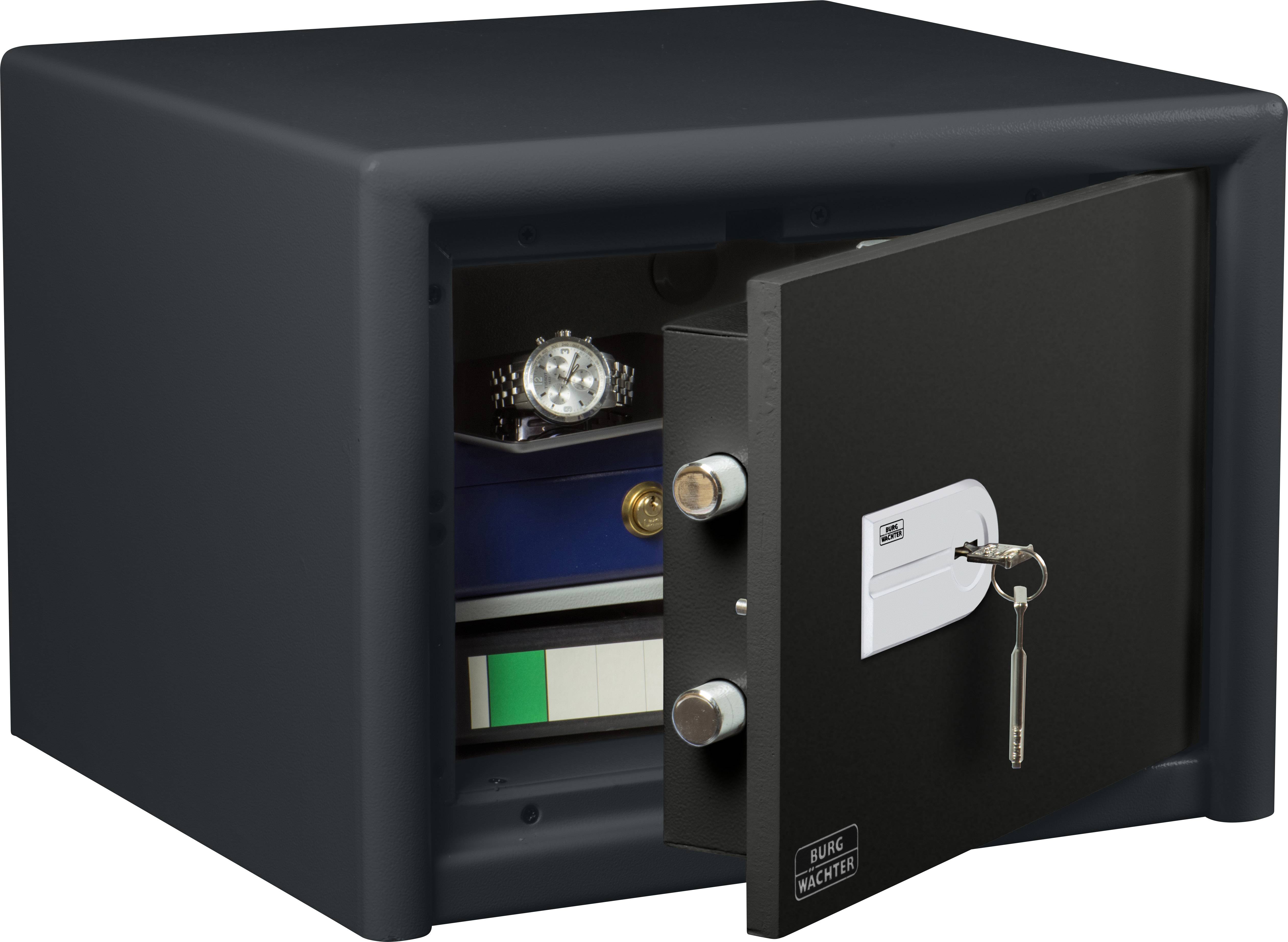 An open safe reveals watches and ring binders inside. A key is inserted in the lock of the safe door.