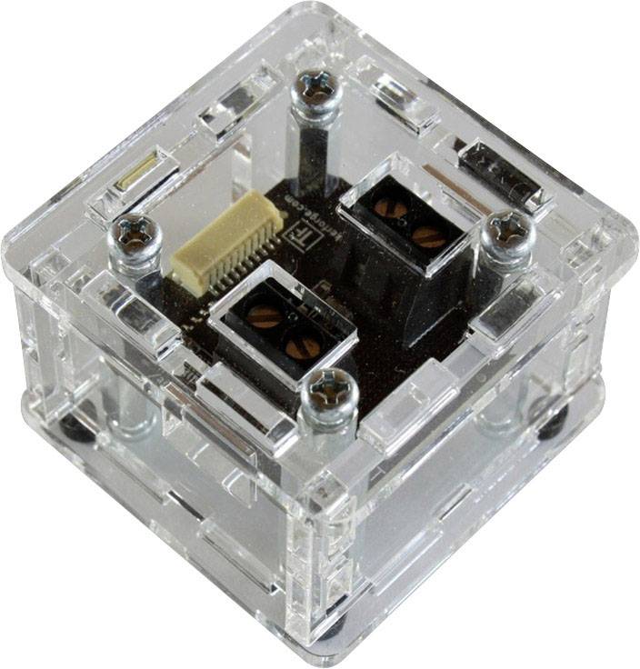 Transparent, cube-shaped switch with visible electronic components and screws, integrated into clear plastic.