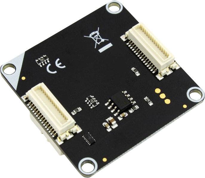 Square electronic component with two connectors and multiple printed circuit board parts on a black surface.