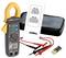 Digital clamp meter with display, two test leads and instruction manual, ideal for measuring electrical voltages.