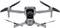 A grey drone with four propellers hovers. It is equipped with a camera. The drone is technologically advanced.
