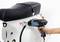 A hand holds a heat gun close to a scooter. A heart sticker is located on the scooter.