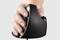 A hand holding an ergonomic vertical mouse. Ideal for preventing wrist strain during computer work.