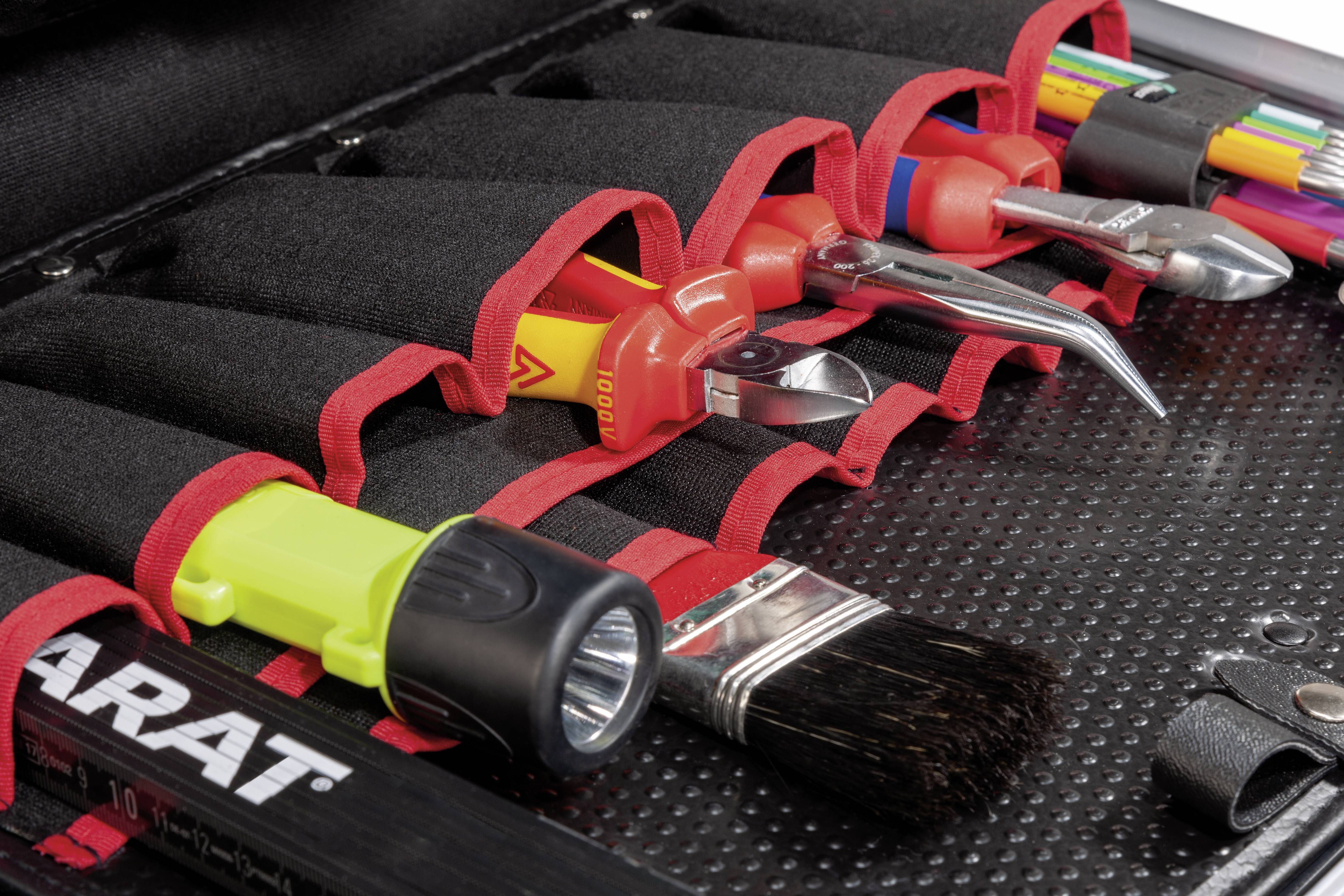 Tool bag with various tools such as screwdriver, pliers, brush and torch, organised in compartments.