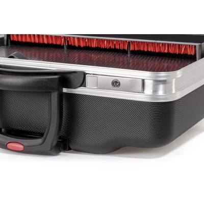 Close-up of a hard-shell suitcase with red inner lining and a black handle. Focuses on the material and structure.