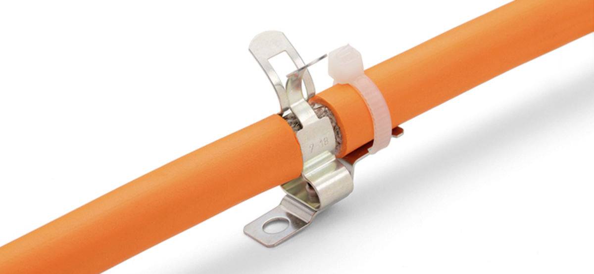 An orange cable is secured by a metal clip with a plastic fastener. The clip is fixed with a screw.