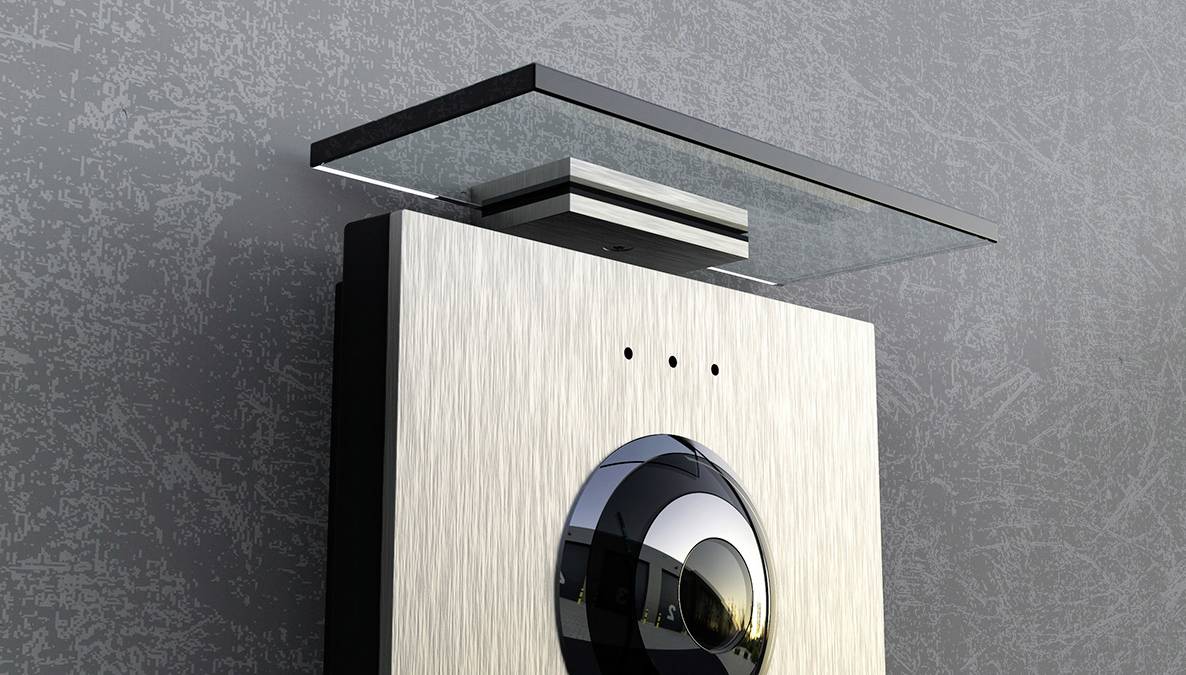 A modern intercom with camera and stylish design mounted on a wall.