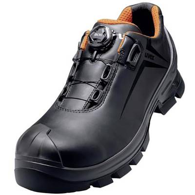 Black safety shoe with orange inner lining and robust tread. Features a closure system for secure fit.