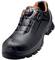 Black safety shoe with orange inner lining and robust tread. Features a closure system for secure fit.