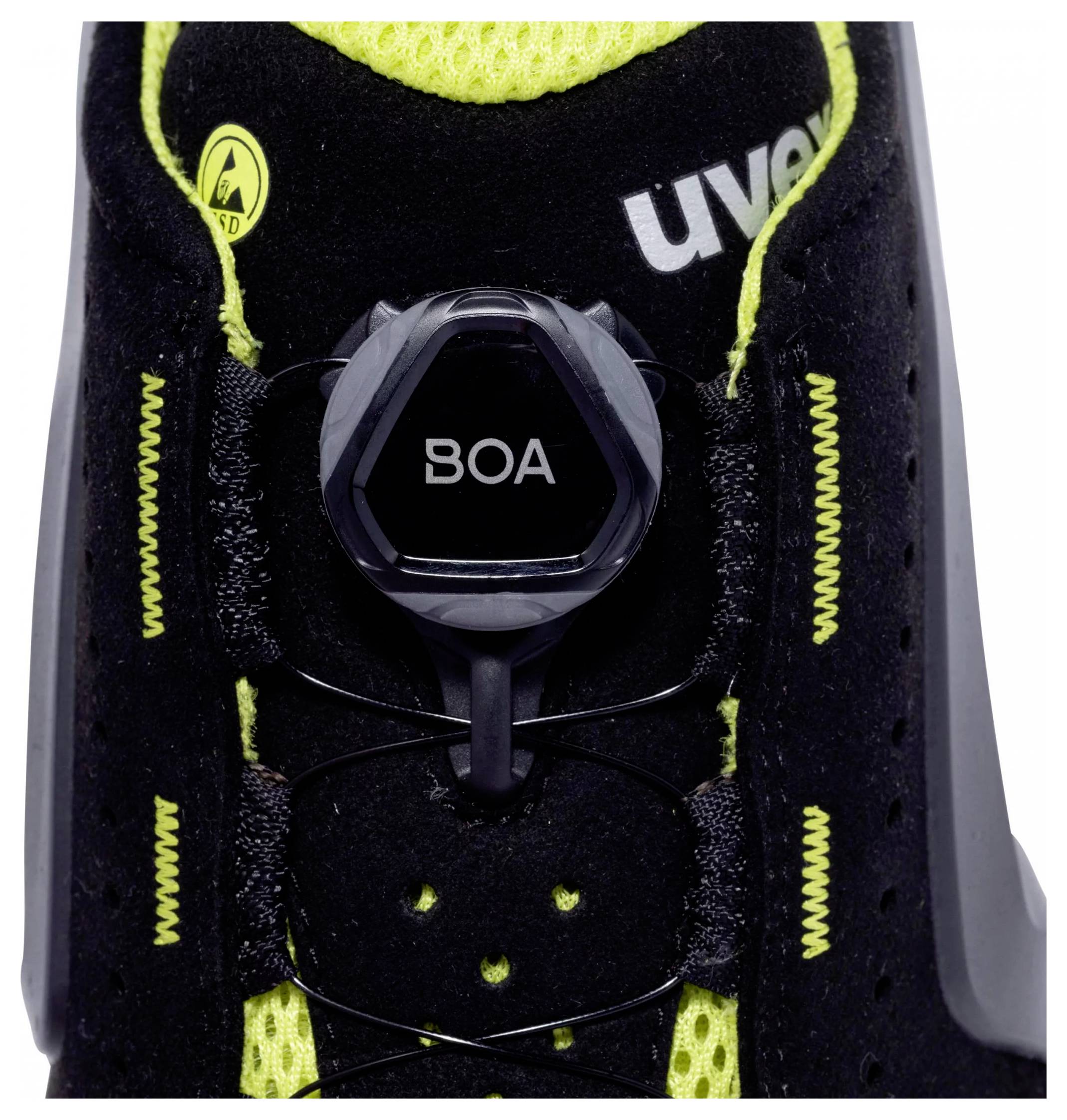 Black shoe with green inner lining, yellow logo and a 'BOA' twist fastener in the centre for individual adjustment.