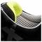Close-up of the inner lining of a black sports shoe with a neon yellow accent and grey mesh fabric.