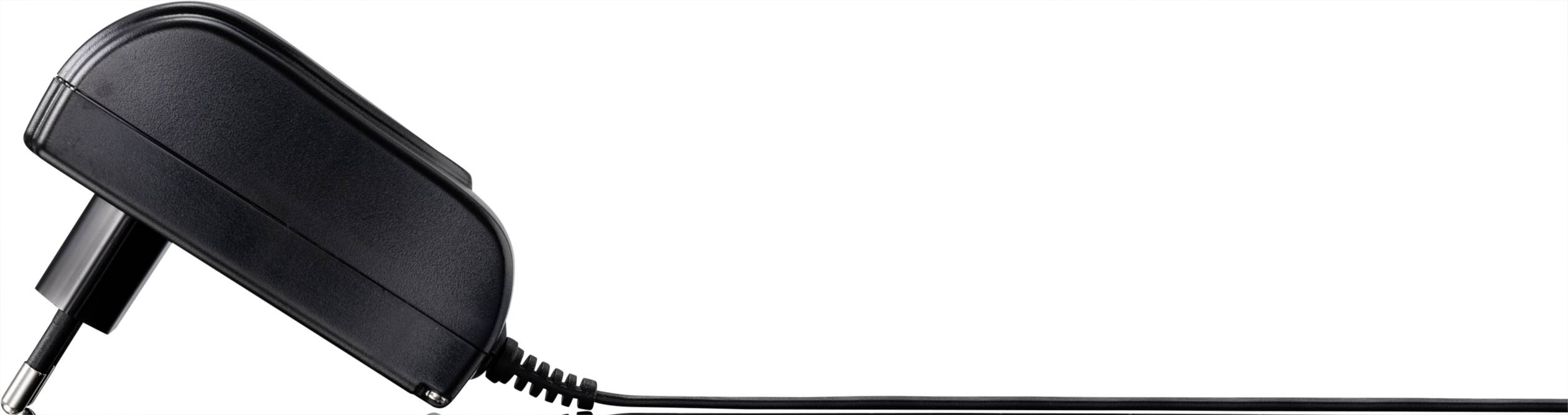 Black power supply with cable on white background, side view.