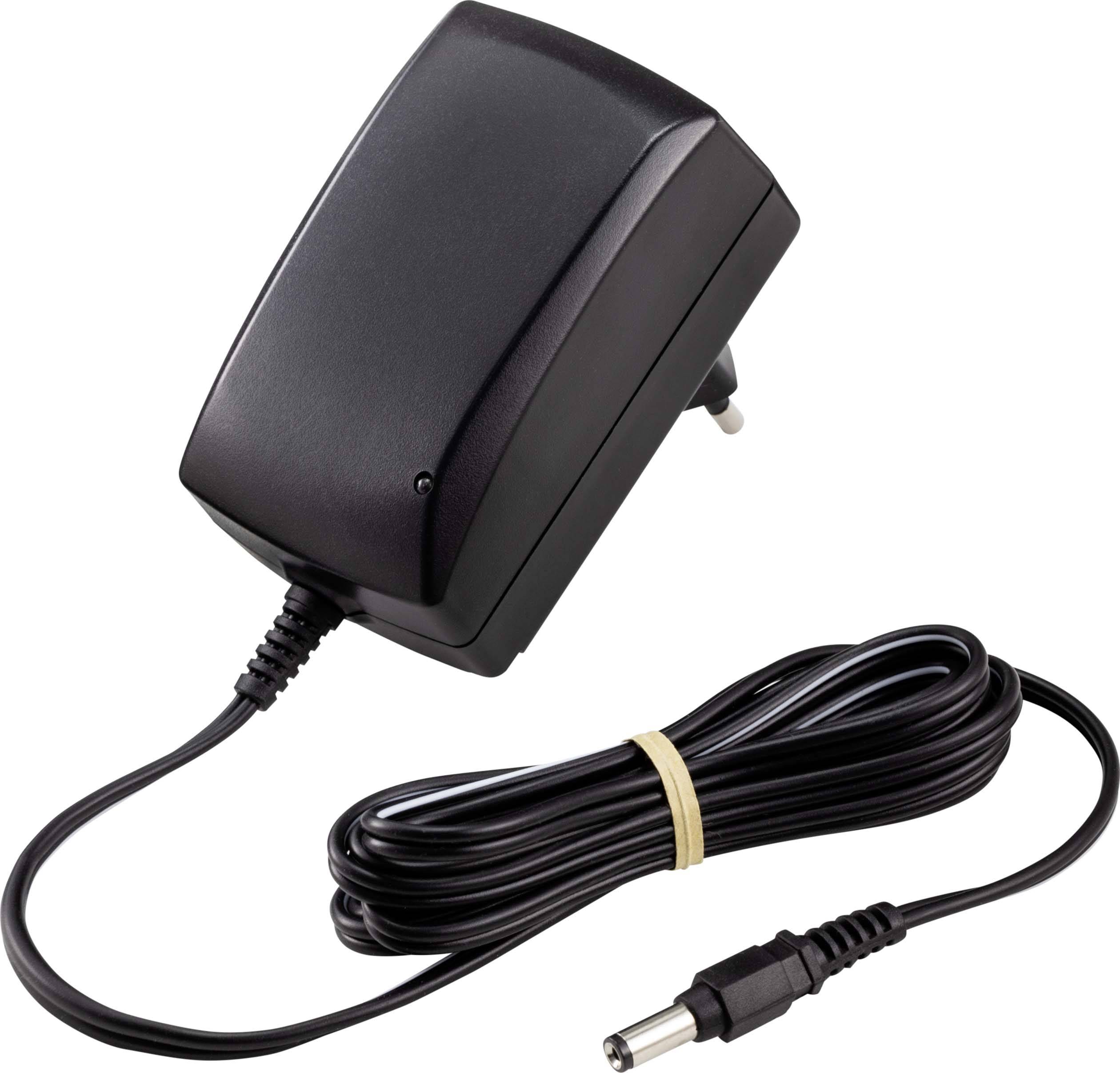 Black power supply with cable and plug, suitable for electronic devices, placed next to a power socket.
