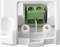 Close-up of a white housing with a green clip for electrical connections, two visible screws for fastening.