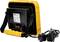 Yellow LED construction floodlight with black housing and power cable. Rear view shows handle and stand. Suitable for construction site lighting.