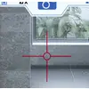 A digital camera viewfinder shows green foliage in front of a window, framed by grey tiles.