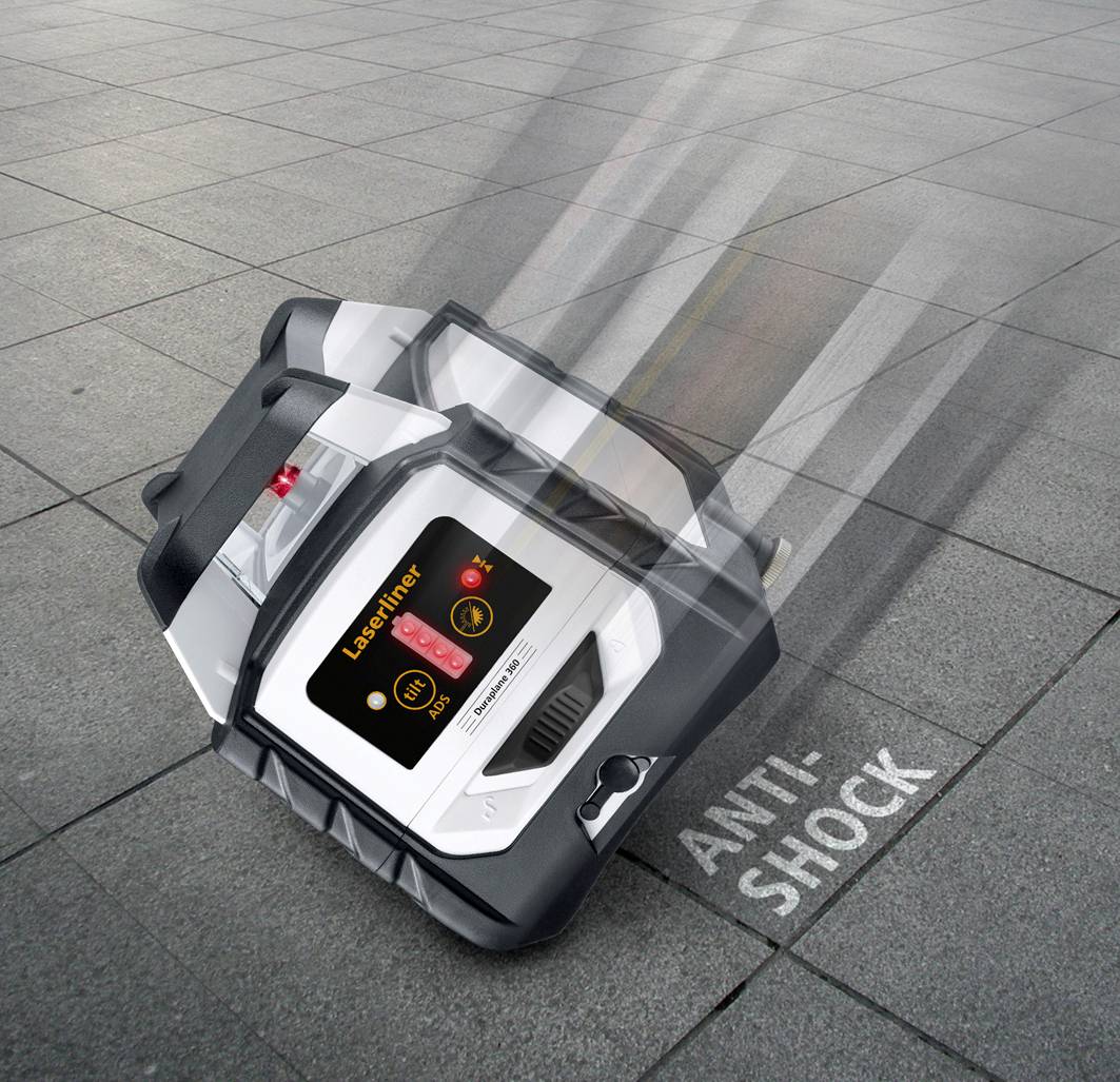 A laser levelling device with a robust housing falls onto floor tiles. The inscription 'Anti-Shock' emphasises its shock resistance.