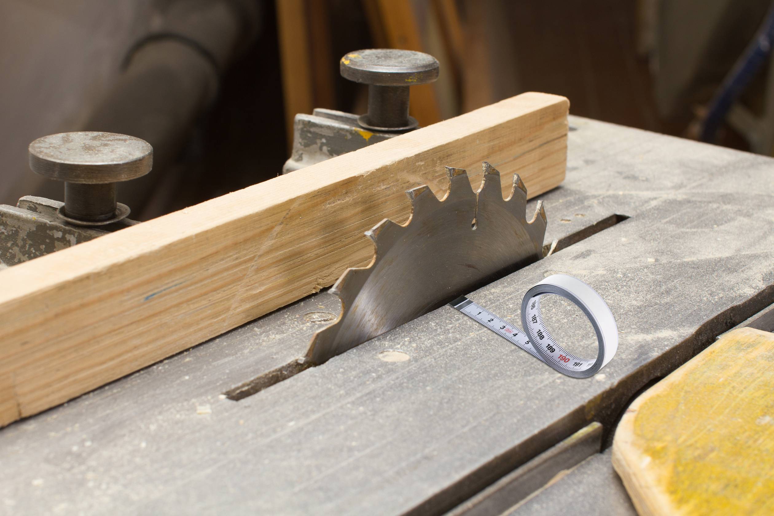 Table circular saw with tape measure for depth measurement.