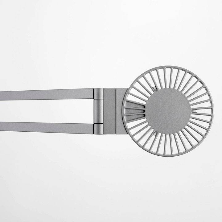 A silver, contemporary wall shelf with a round, grid-like design on the right side and flat arms on the left.