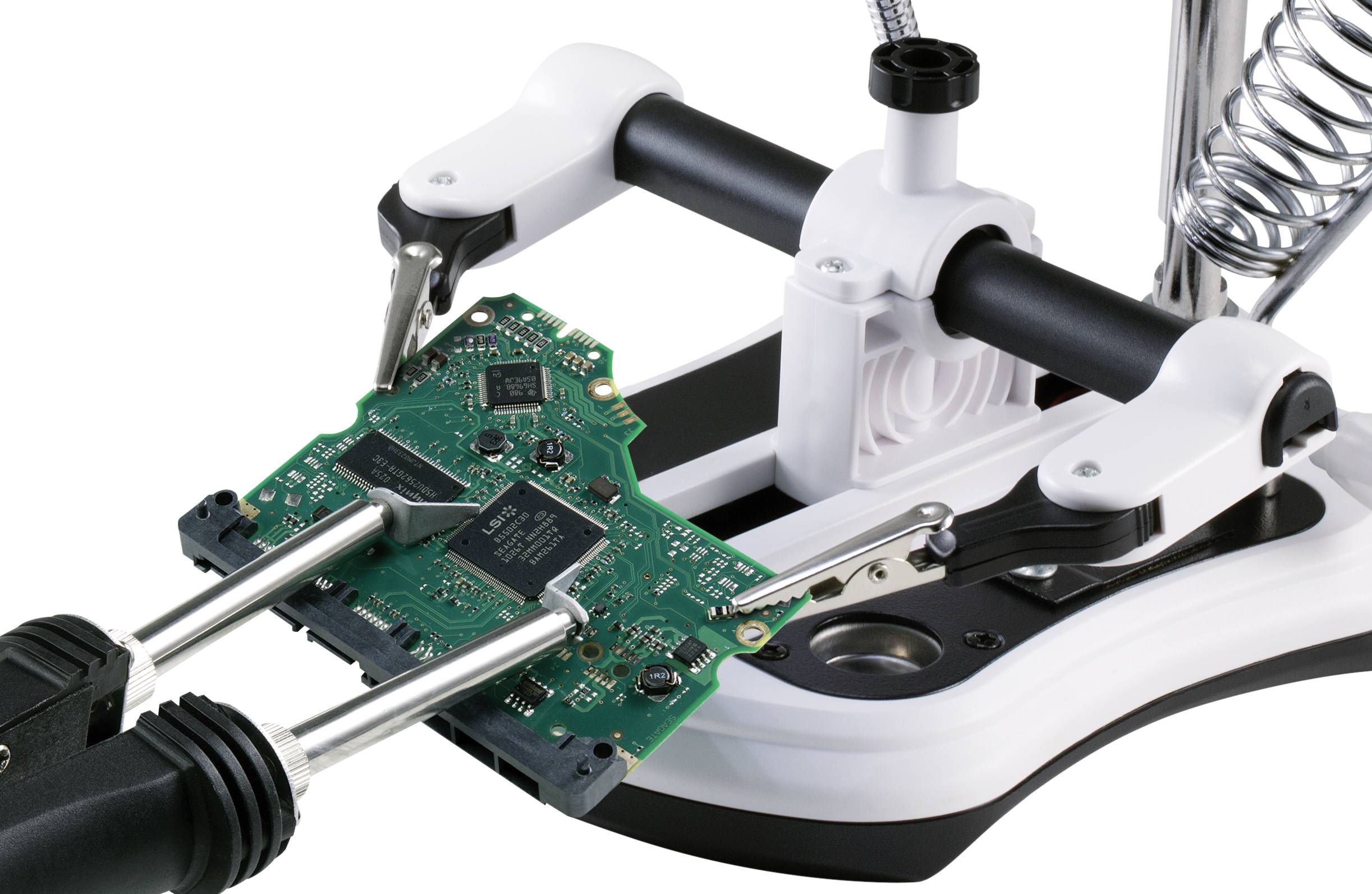 A circuit board is secured by a soldering third-hand holder. Ready for soldering work to attach electronic components.