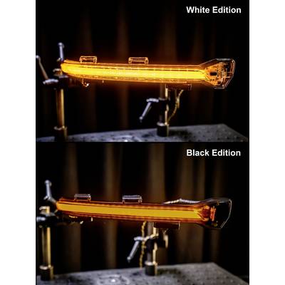 Two blinking lights compared: Upper 'White Edition' shows brightly illuminated orange light, lower 'Black Edition' similarly. Both mounted on stands.