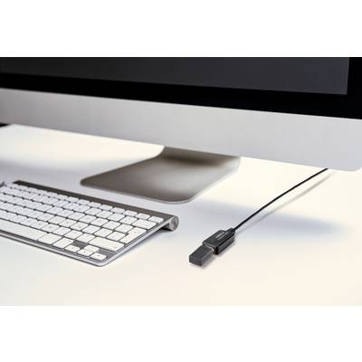 A desktop computer shows a connected wireless keyboard and a USB memory stick plugged into the side of the monitor.