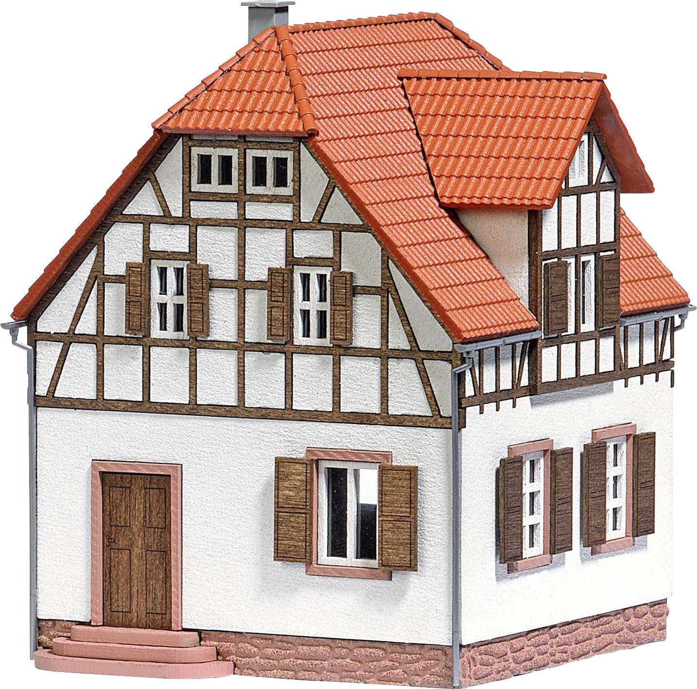 A two-storey half-timbered house with a red tiled roof, three windows and a wooden door. Square-arranged windows and white-plastered walls.