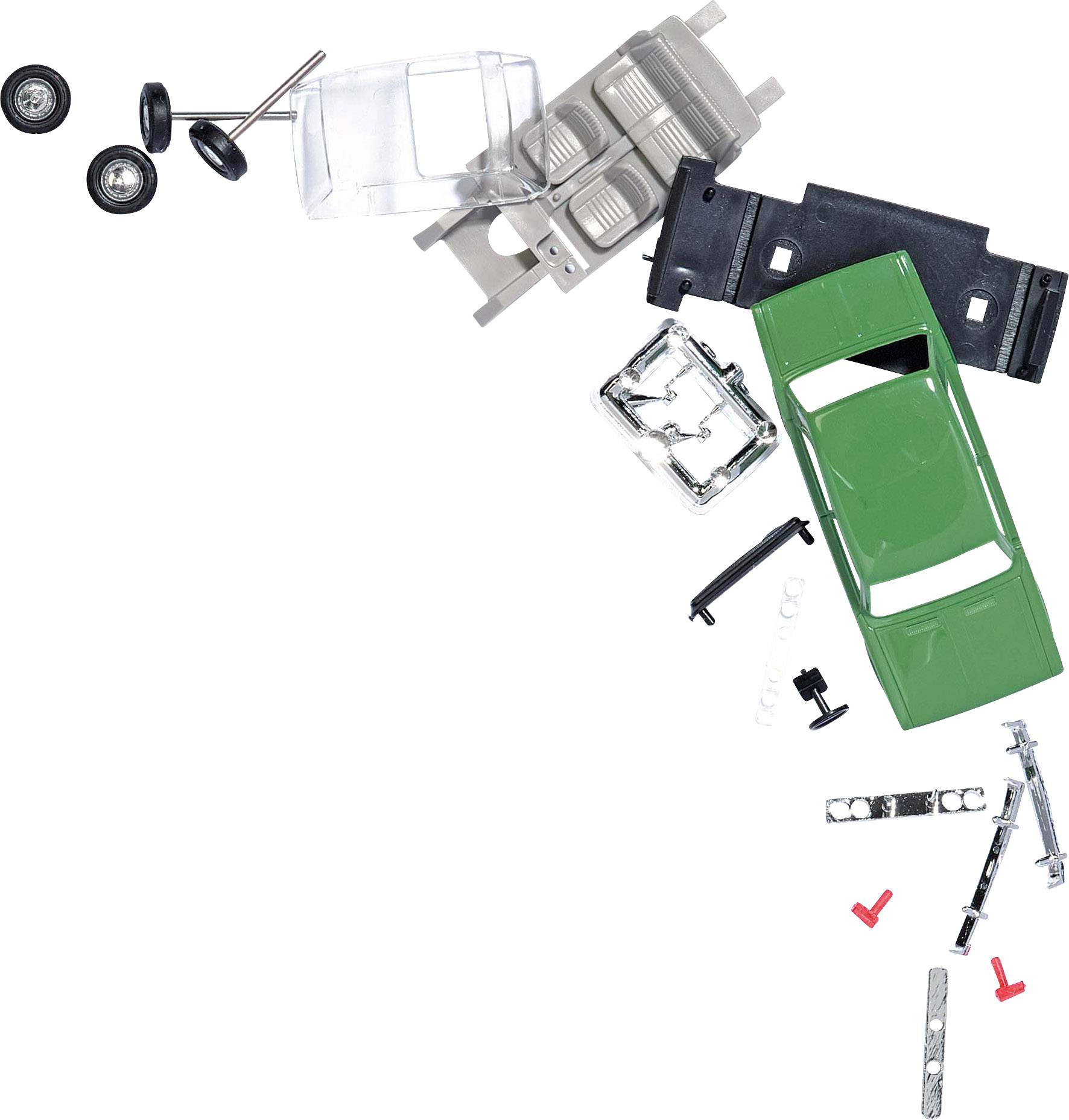 A dismantled green toy car shows various parts such as bodywork, wheels, and chassis arranged in a curve.