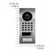 Door entry intercom; rectangular, stainless steel; camera at the top; keypad below; doorbell button with bell symbol underneath; dimensions: 15.19 cm x 6.50 cm.