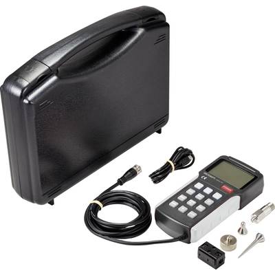 A digital measuring device with cables and accessories next to a black case.
