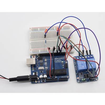 Arduino kit with breadboard, wiring and relay module. The breadboard is connected to LEDs and a resistor, with all components electrically wired.