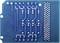 Back of a blue printed circuit board with visible copper tracks and solder points. Predominantly horizontal and vertical line patterns.