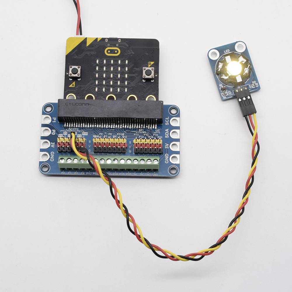 An electronic circuit with a microcontroller on a board, connected to an illuminated sensor, is shown.