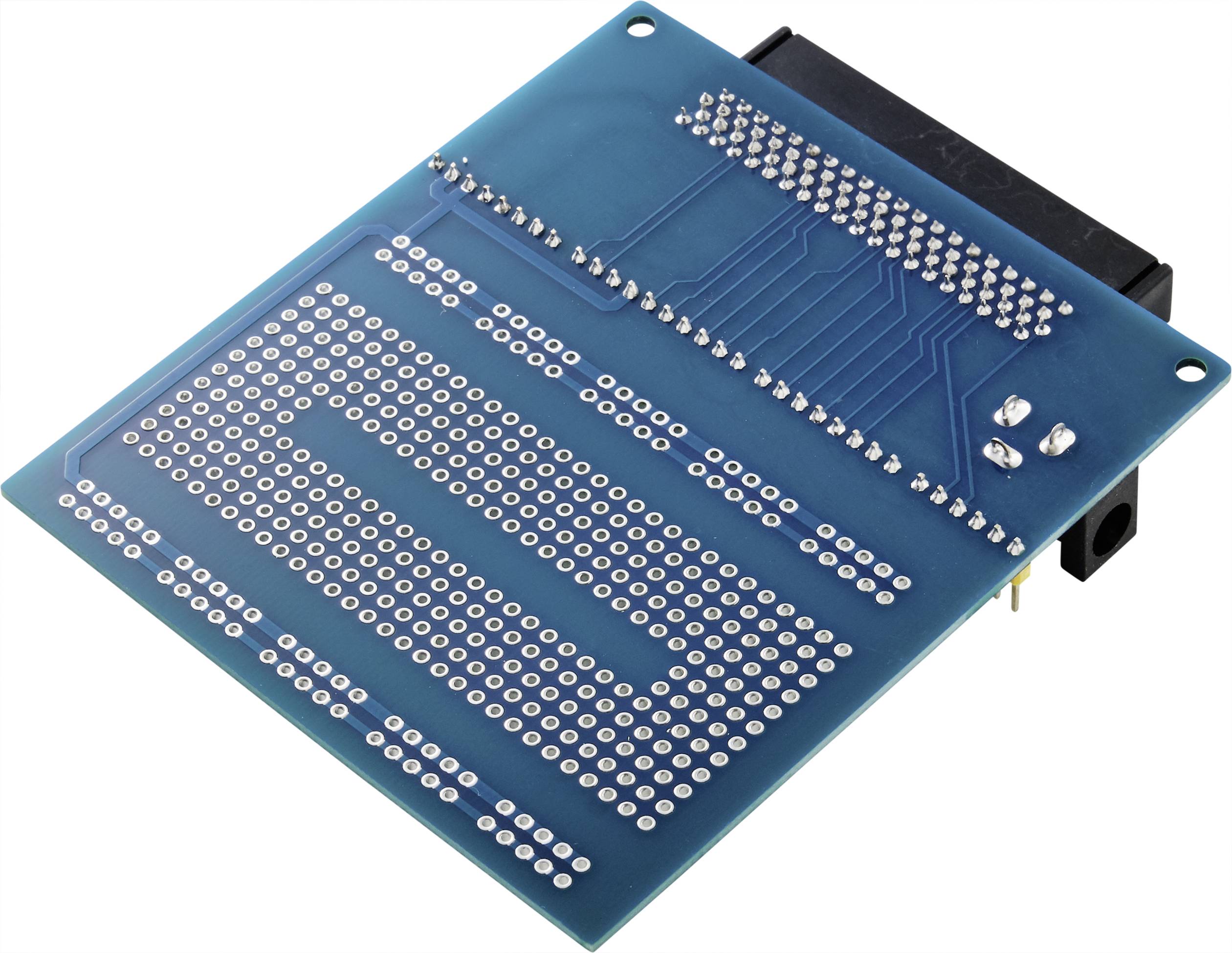 A green electronic circuit board with numerous open soldering points and connecting tracks on its surface.