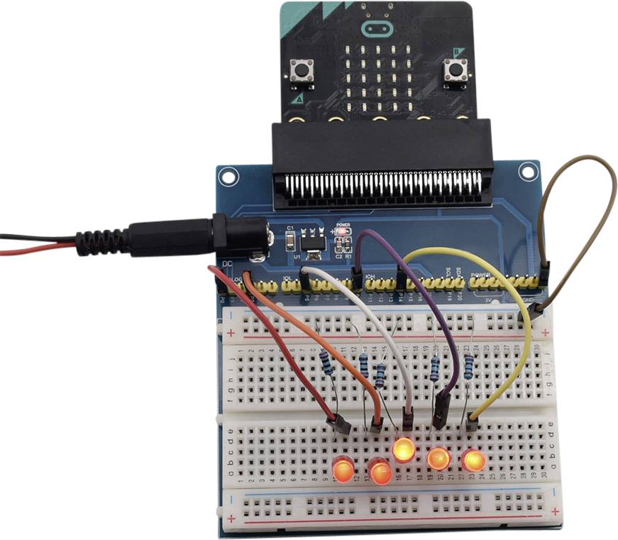 A microcontroller on a breadboard, connected to several illuminated LEDs. It demonstrates a basic circuit project.