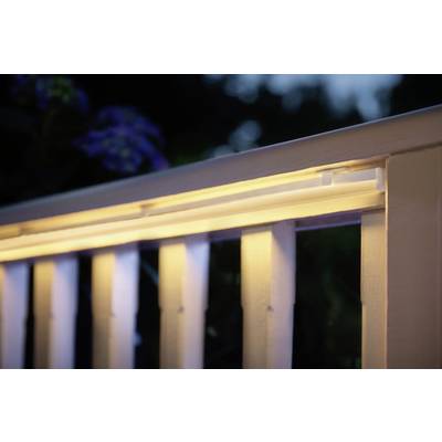 Illuminated handrail at dusk. Warm light radiates along the upper rail, creating an inviting atmosphere in the background.
