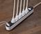 A white multi-socket extension lead with six plugged-in cables is lying on a wooden table.