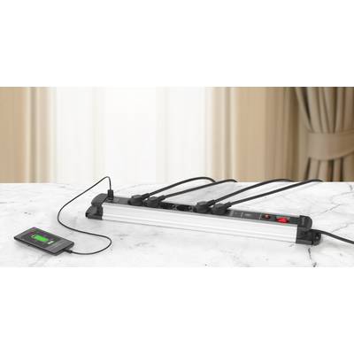 A smartphone is being charged via a charger connected to a multi-socket extension. The socket has five occupied ports.