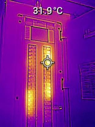 Thermal image of a door shows hot areas up to 31.9°C, depicted in yellow and orange. Surrounding environment darker, cooler.