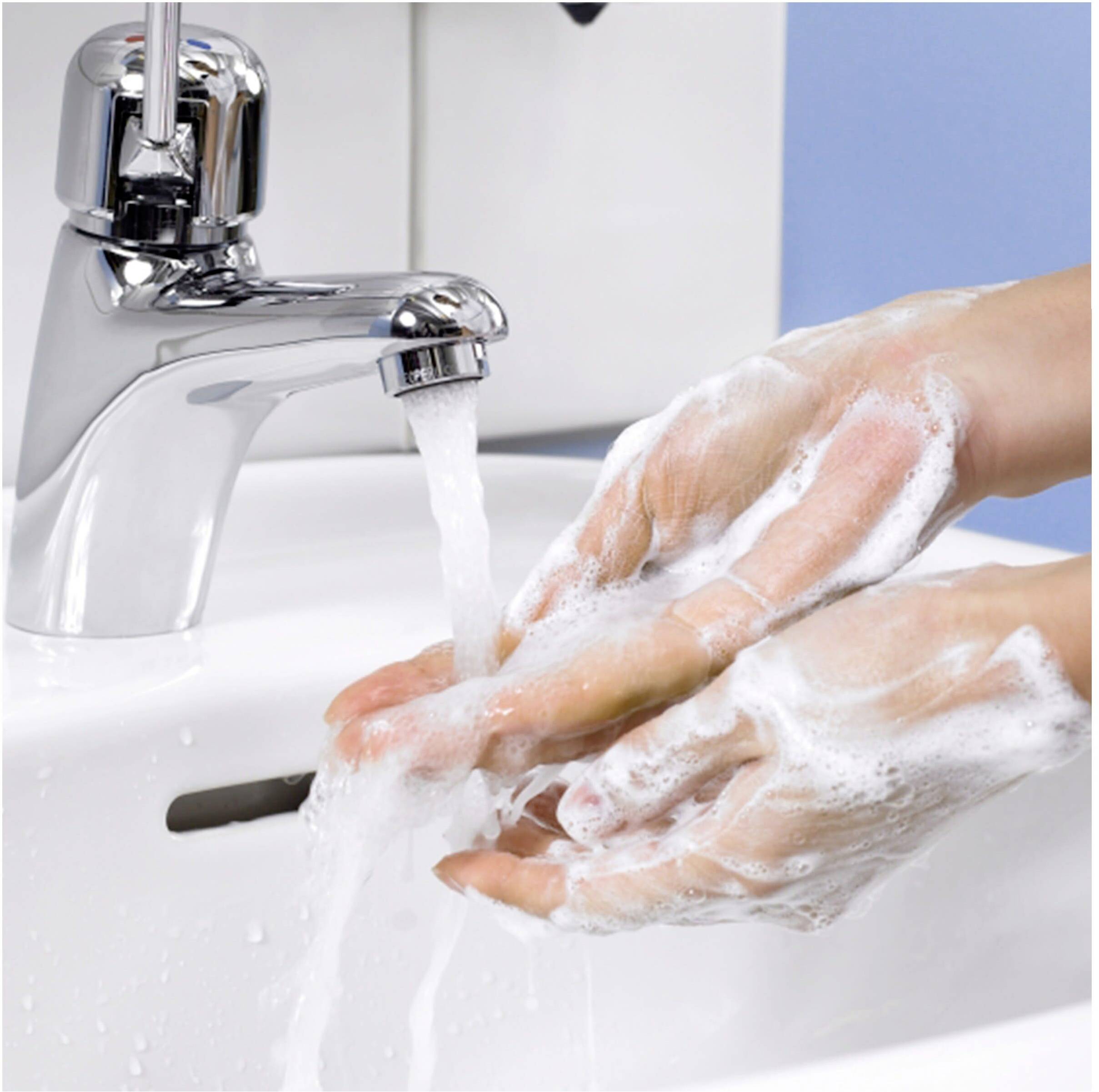 A person is washing their hands with water and soap at a sink to ensure hygiene and cleanliness.