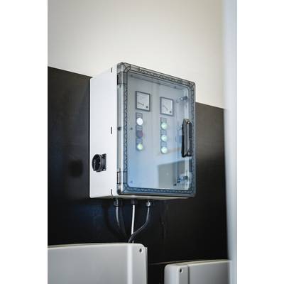 Electrical control panel mounted on the wall with indicator lights and switches for controlling technical equipment.